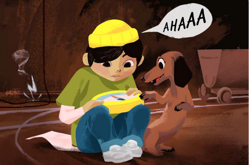 Der Junge Basti und seine Hündin Bella sitzen in auf dem Boden einer Bergwerk-Höhle und schauen auf den Kompass in Basti's Händen.